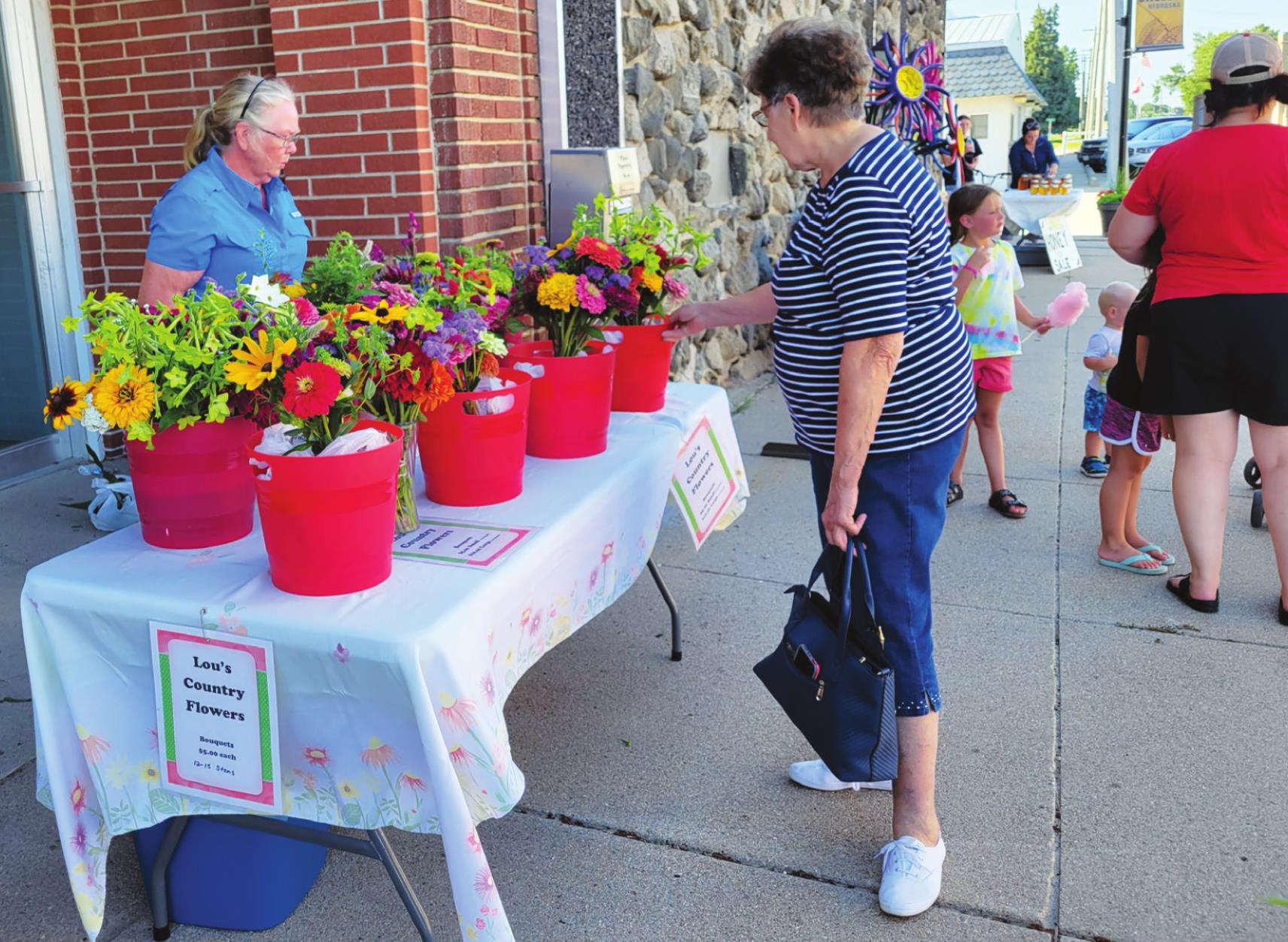Lou Kresha has flowers for sale at the farmers market.