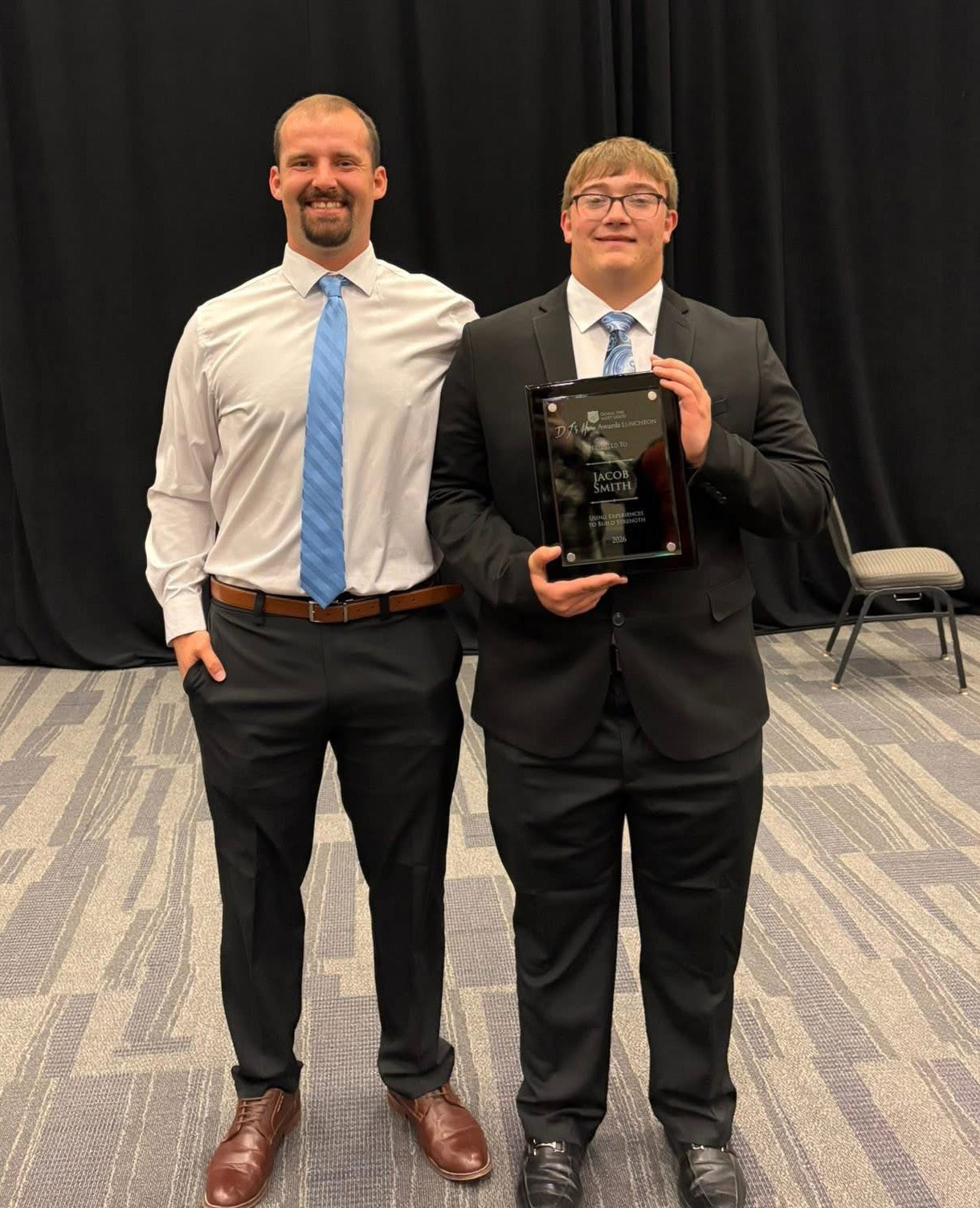 Above: Cross County P.E. teacher and coach, Trent Grizzle (left) is pictured with senior Jacob Smith. Smith recently was honored by the Salvation Army as one of 19 students in the state chosen for the DJ’s Hero Award. Photo provided.
