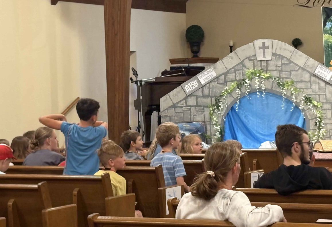 Vacation Bible School is going on now at Stromsburg Evangelical Free Church. Kids here are singing along with Summer Lukasiewicz and Lexi Eller (below) and answering what they learned (above). PCN photos by Beth Sparrow.