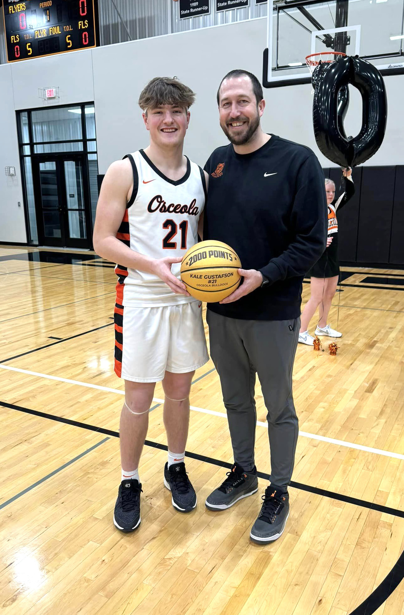 Kale Gustafson became one of four people in Nebraska history to have 2000 points and 1000 rebounds. He finished his career with 2037 points and 1227 rebounds. He is pictured here with his Coach Jason Zelasney. Photo provided.