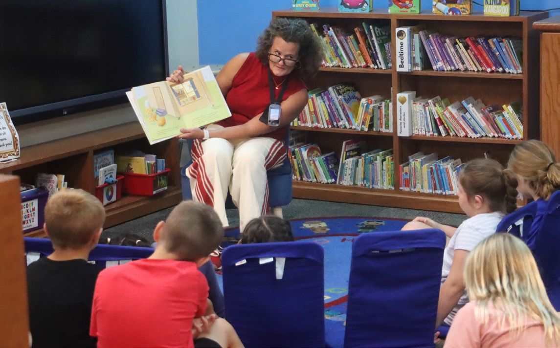 Above: Senator Jana Hughes visited Shelby-RC Schools on Tuesday. Here she is shown reading a book about squirrels to the third grade class in the community library. PCN photo by Ken Kush