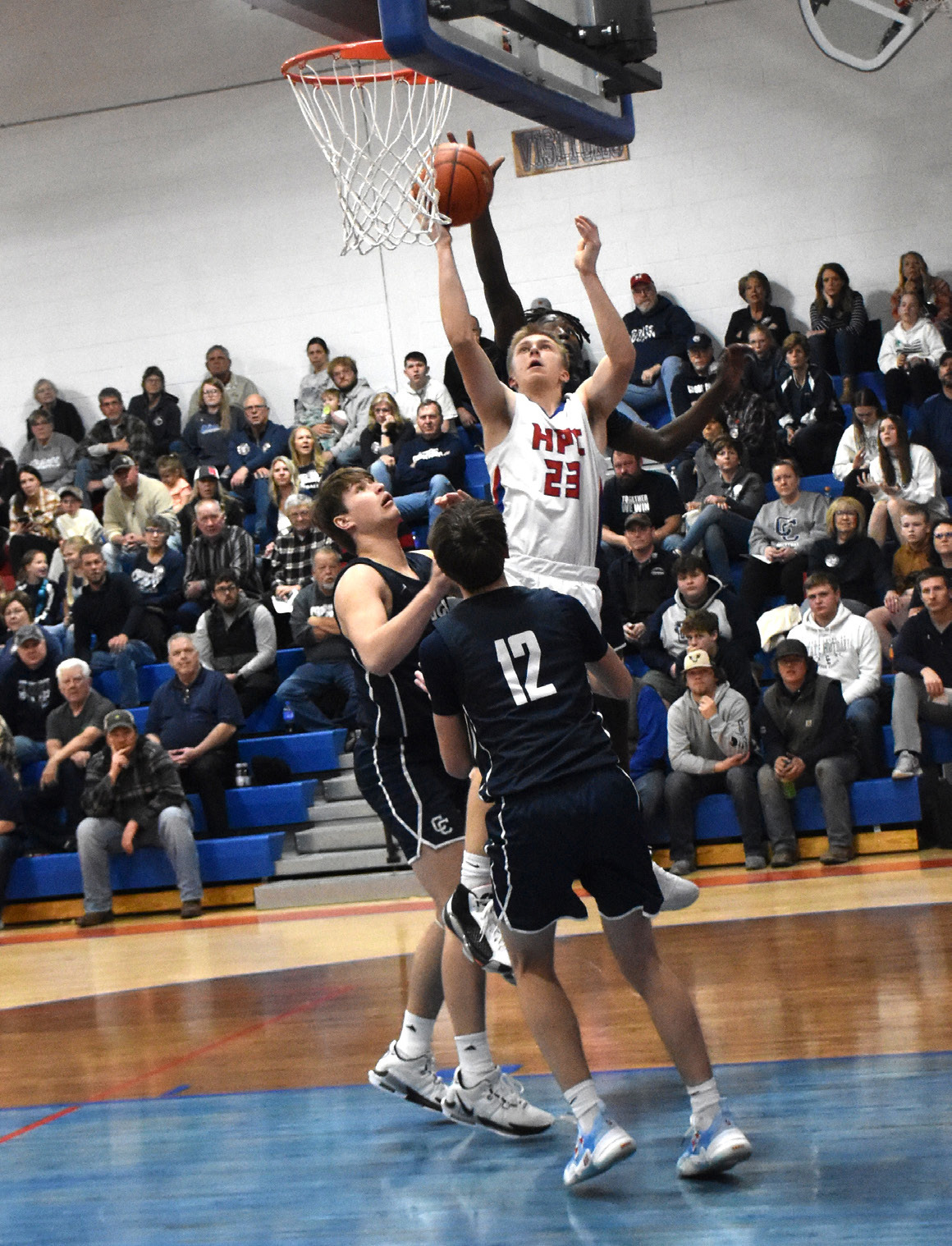 Brodey Spurling (HPC) and James Elgin (CC, behind him) fight for the rebound. PCN photo by Beth Sparrow.