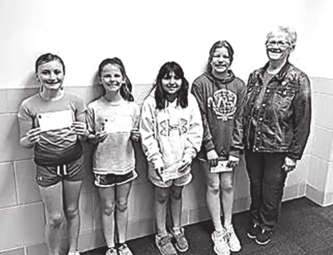 Poppy poster winners: (left to right) first place Cedrynna Rystrom, second place Olivia Linn, third place Jazlyn Rascon, and fourth place Brynley Pfeffer pictured with Pat Everingham.