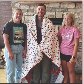 Alex Snyder received The Quilt of Valor on Sunday, September 10th, at his parents’ home near Clarks. Alex is a 2011 graduate of Cross County High School. He served 8 years in the Marines and was deployed with the 31st MEU in support of Operations Enduring Freedom. The quilt was made by Chesney and Cortlyn Sundberg of Stromsburg as part of their 4-H project. Pictured are Chesney Sundberg, Alex Snyder and Cortlyn Sundberg. Photo provided.