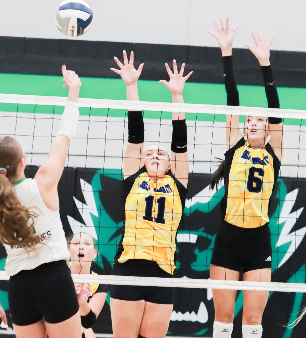 Junior Madison Augustin and senior Leah Whitmore set up the Huskies block against the Wilber Clatonia front line attack. PCN photo by Ken Kush.