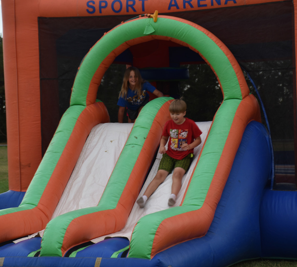 Kids enjoyed the bouncy houses, and a couple boys practiced baseball at the holiday celebration. Food, water games and fireworks followed. PCN Photos by Beth Sparrow.