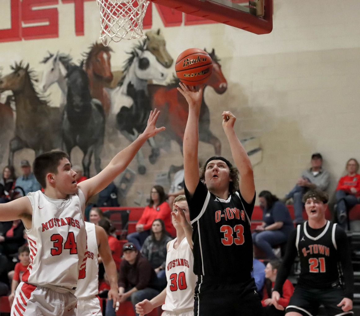 Koleton Udey goes up for the basket with Kale Gustafson in the background. PCN photo by Blaine Winslow.