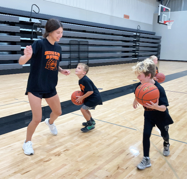 Rori Wiseman, left, plays  defense on Braxton Borer last week at Osceola Schools Youth Basketball Camp before the camp session began. Zane Bise works on his mid-range jump shot before the camp session began. Camps continued this week as the Lil'Dawgs Football Camp kicked off Monday and Tuesday and continues today and Friday for first through third grade and fourth through eighth grade. Polk County News photo by Rick Holtz