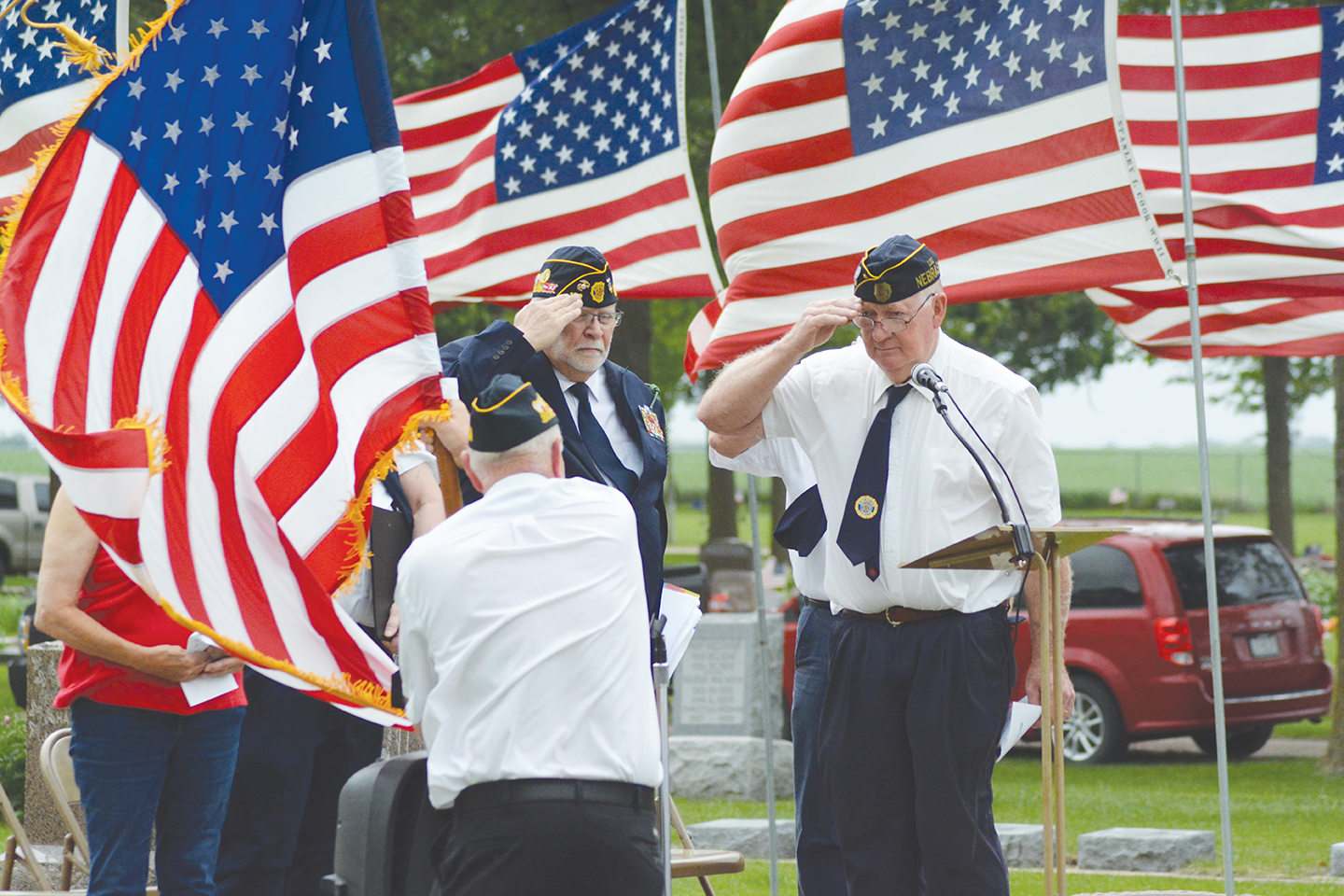 Stromsburg American Legion Commander Perry Noyd (right) salutes the American flag Monday morning at the Memorial Day Services at the Stromsburg Cemetery. Close to 200 people were on hand to honor and remember the fallen soldiers. Photo by Rick Holtz