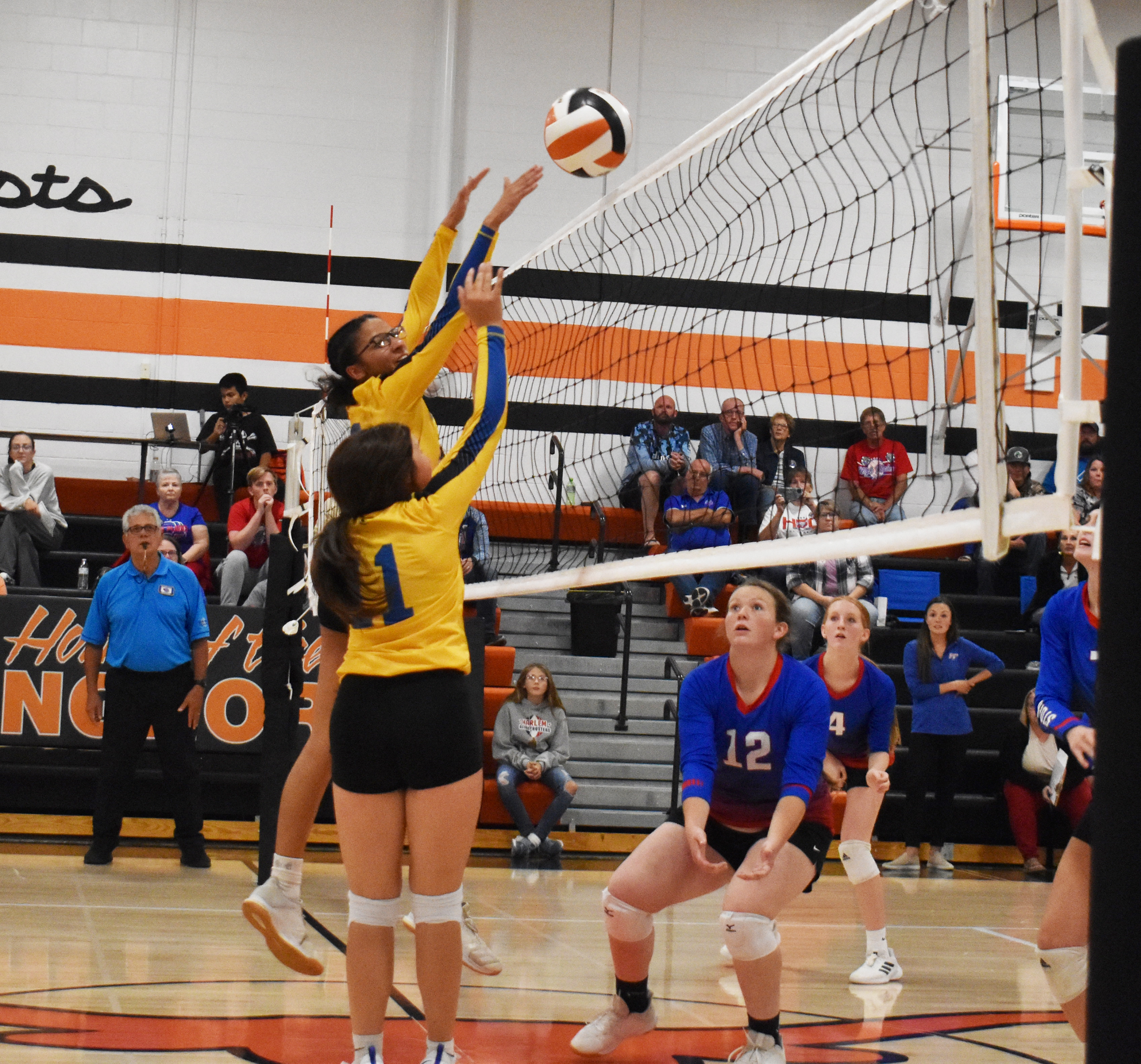 SRC’s Zoey Walker and Brooklynn Baker go for a tip as High Plain’s Allie Howell prepares for the ball to come back over the net. PCN photo by Beth Sparrow
