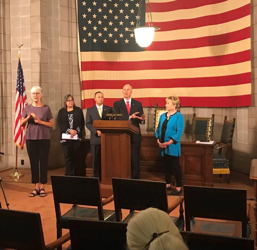 From Left to Right: ASL Interpreter Frances Beaurivage, Property Tax Administrator Ruth Sorensen,  Tax Commissioner Tony Fulton, Gov. Ricketts (podium), and State Senator Lou Ann Linehan. Photo provided