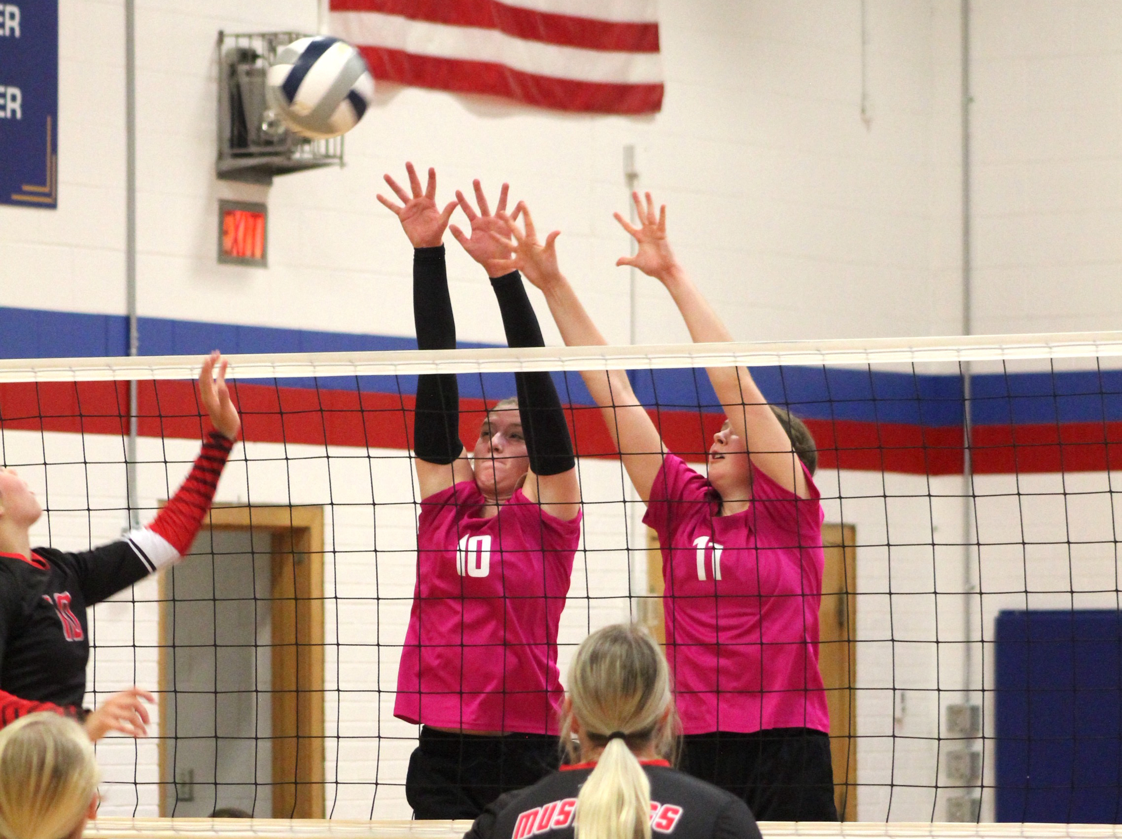 Courtney Carlstrom and Rylie Ackerson go for a block against Meridian. High Plains photo