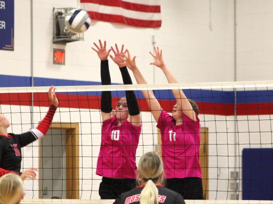 Courtney Carlstrom and Rylie Ackerson go for a block against Meridian earlier this season. High Plains photo