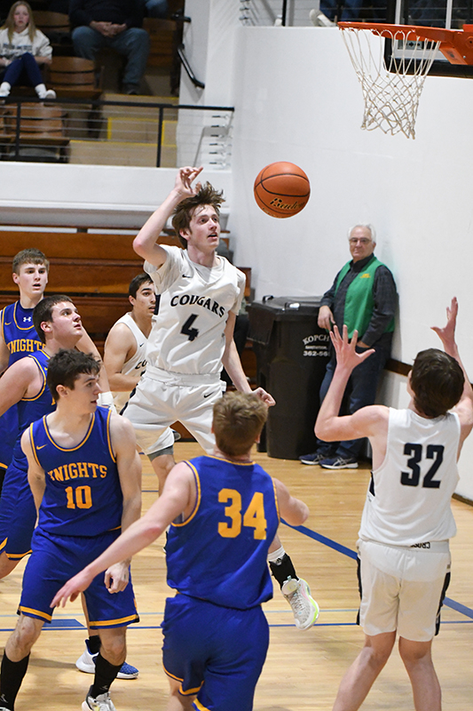 Levi Miller drives to the basket and passes the ball to a cutting Wyatt Hengelfelt, who is open underneath the basket. PCN photo by Rick Holtz