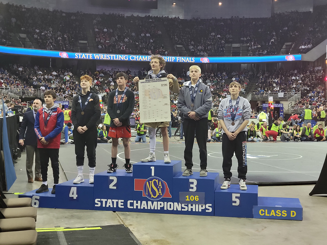 Though he does not attend a Polk County high school, Shelby resident Grady Romshek, a senior at Aquinas Catholic in David City, stood tall as the Class D 106-pound champion. Also on the podium with him was Shelby-Rising City's Owen Krafka, who finished third, and High Plains' Levi Russell, who finished sixth. PCN photo by Beth Sparrow