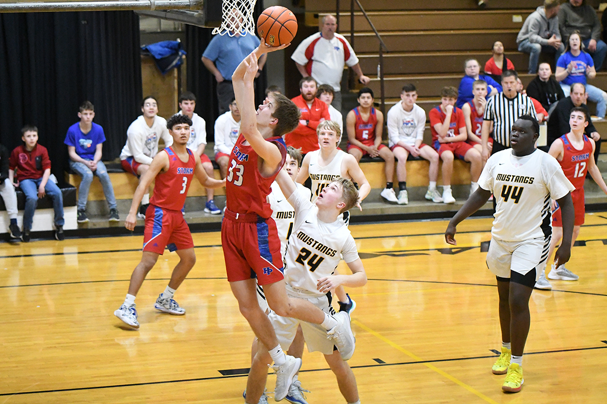 Carter Urkoski finishes at the basket and draws a foul on the Mustang defender in the third quarter on Tuesday. PCN photo by Rick Holtz
