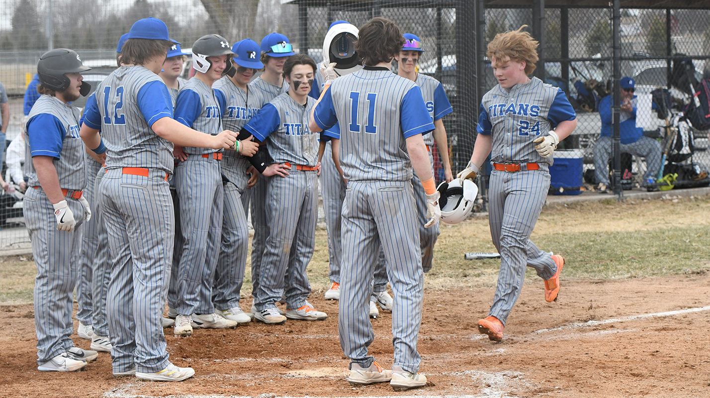 Twin River's bench gathers around home plate as Paydon Rinkol rounds the bases following his second inning two-run home run. PCN photo by Rick Holtz