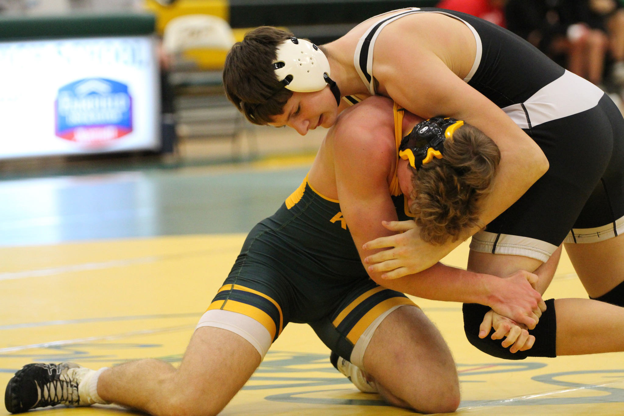 Paxton Burke (CCO) wrestles Austin Smith of Kearney Catholic. PCN photo by Travis Lane.
