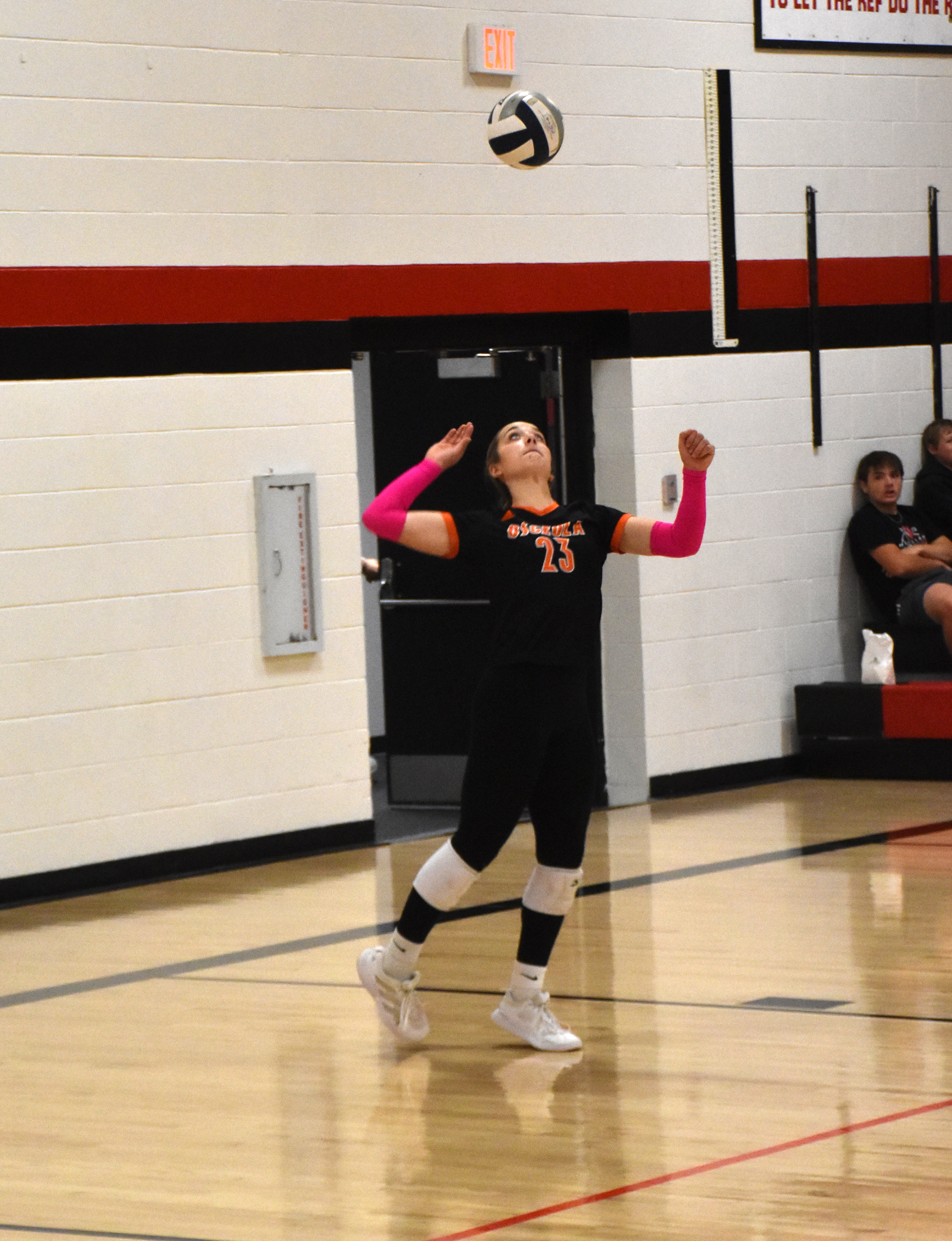 Bella Recker (OSC) serves.