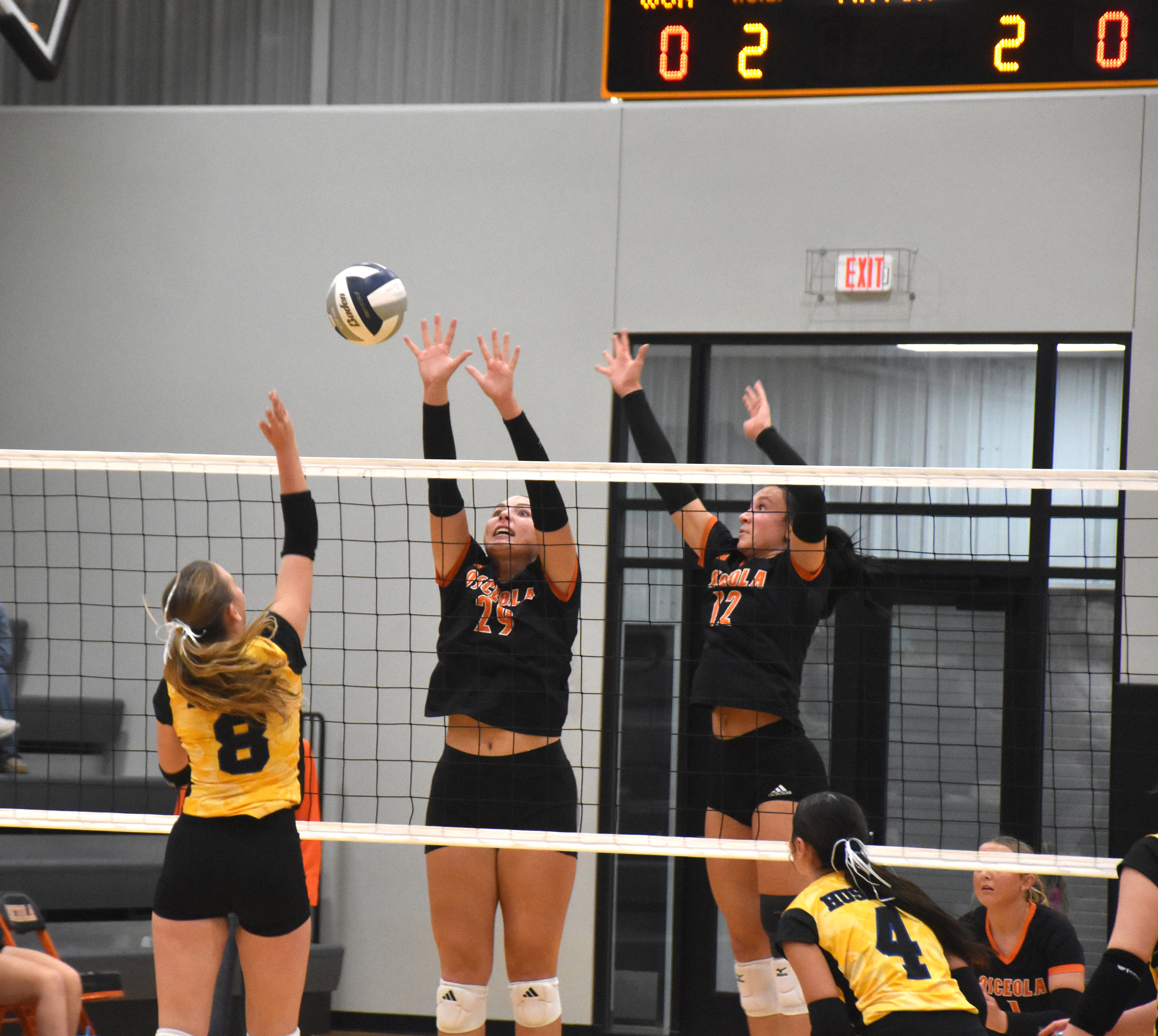 Hayden Hopwood (SRC) goes for a kill as Graci Conkling and Alexis Burritt (OSC) block. PCN photo by Beth Sparrow