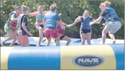 Kids at Royal Family Kids Camp are having fun on a large intertube. Photo provided.