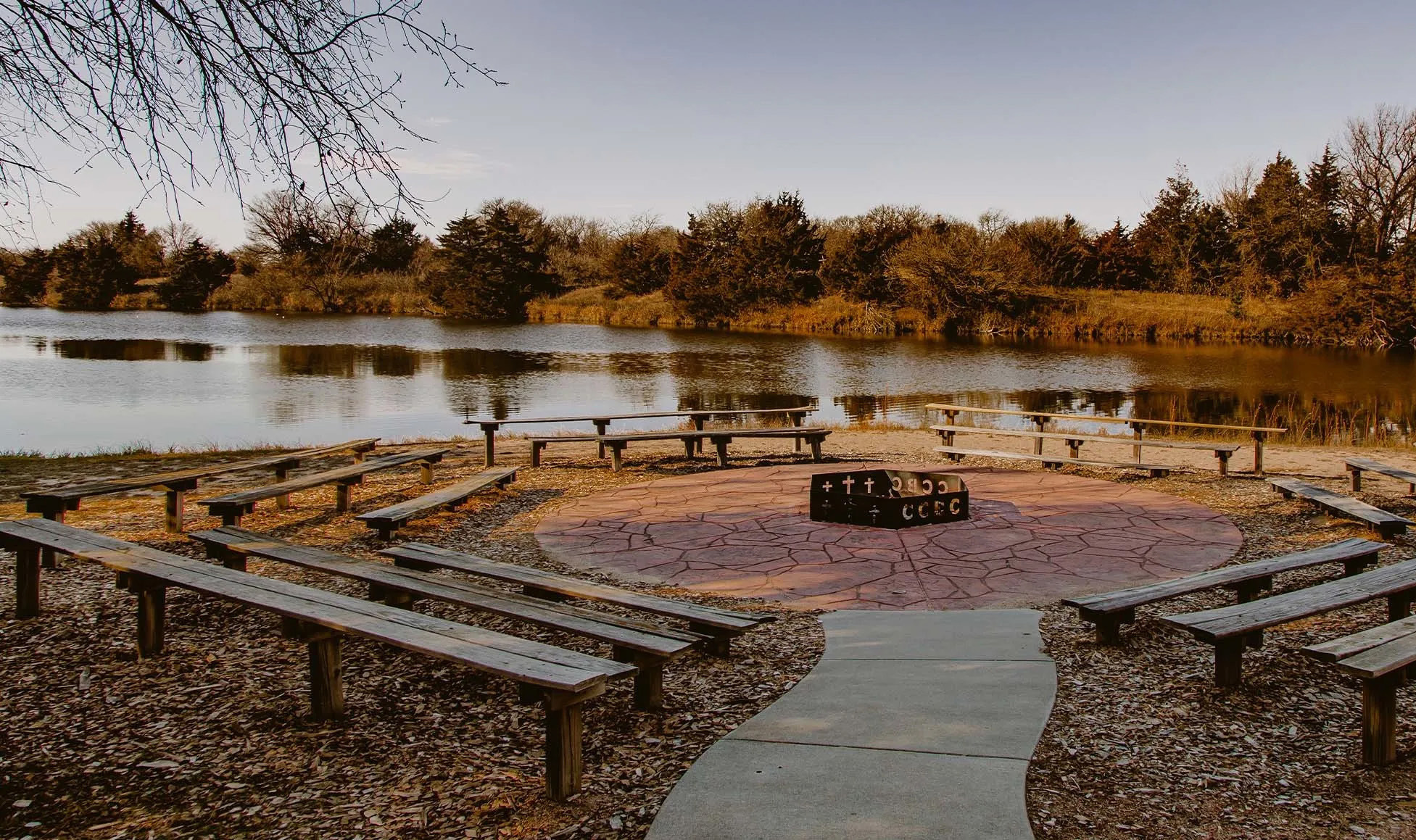 Pictured is the campfire meeting spot. The campfire is located right next to the lake. This is the perfect spot to roast marshmallows or to have worship together around a campfire. It has enough benches to hold small or large gatherings. Photo provided.