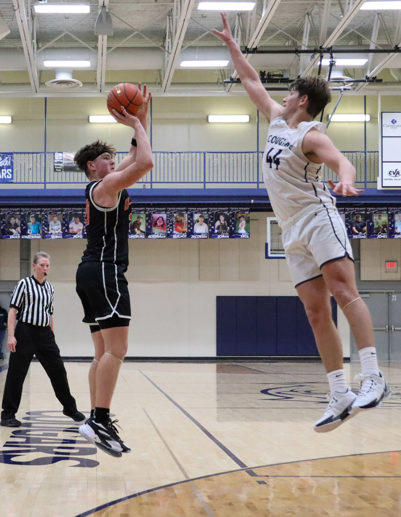 Senior Kale Gustafson (OSC) takes the shot over senior Tanner Hollinger (CC) on Tuesday. 