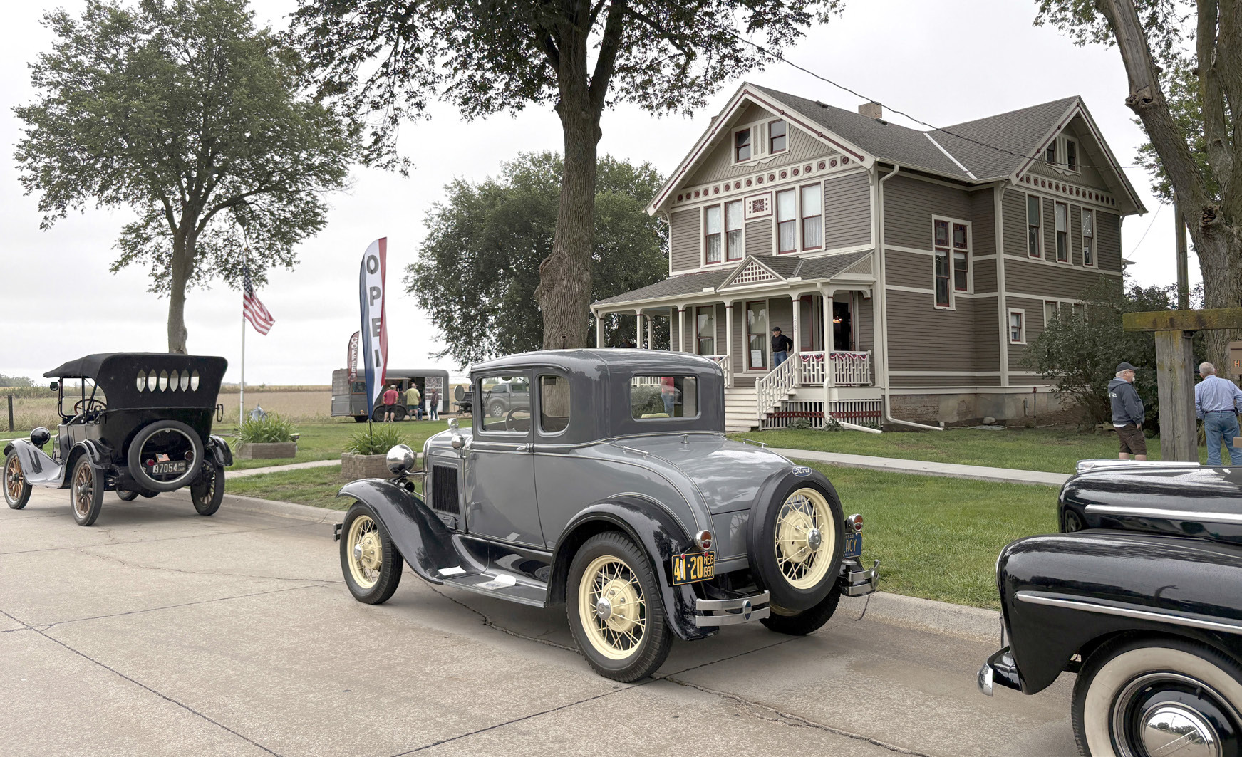 Above: Cars lined the street in front of the museum. People grabbed a drink at Forest Moon’s trailer, visited the buildings and heard Chris Sayre (below) in the old church. The Historical Society is raising money for an additional building. The goal is of $150,000 is shown below with about half already raised. PCN photos by Beth Sparrow.