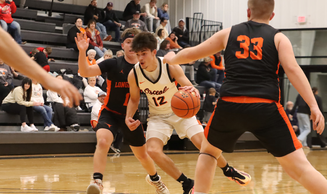 Osceola’s Jackson Winslow (12) drives to the basket in the Bulldogs game with Dorchester. PCN photo by Ken Kush.