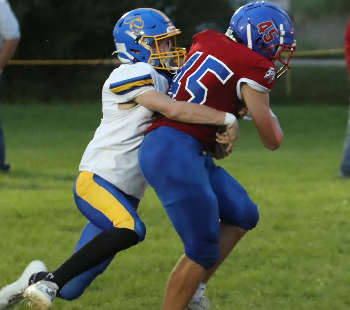Top left- High Plains junior Chase Owens (45) refuses to be denied as he carries the Nebraska Lutheran defender into the end zone on this first quarter 11-yard scoring run. Owens also had a pick-six in the first quarter. 