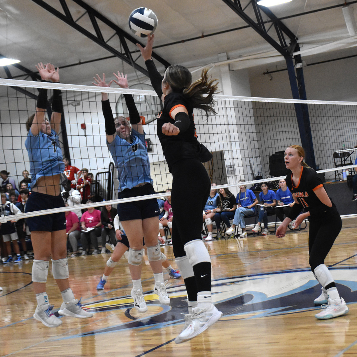 Bella Recker goes for the kill against Nebraska Christian blockers. PCN photo by Beth Sparrow.