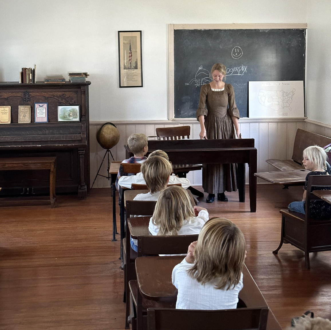 Pictured is Alena Mentink acting like a old-fashioned teacher in the one-room school at the Polk County Museum. Photo provided.