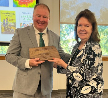 Jarod Ockander of Osceola (left) receives the English teacher of the year from Ann Quinlan. This was presented by NCTE (National Council of Teachers of English) and Ockander teaches at David City Public Schools. Photo provided.