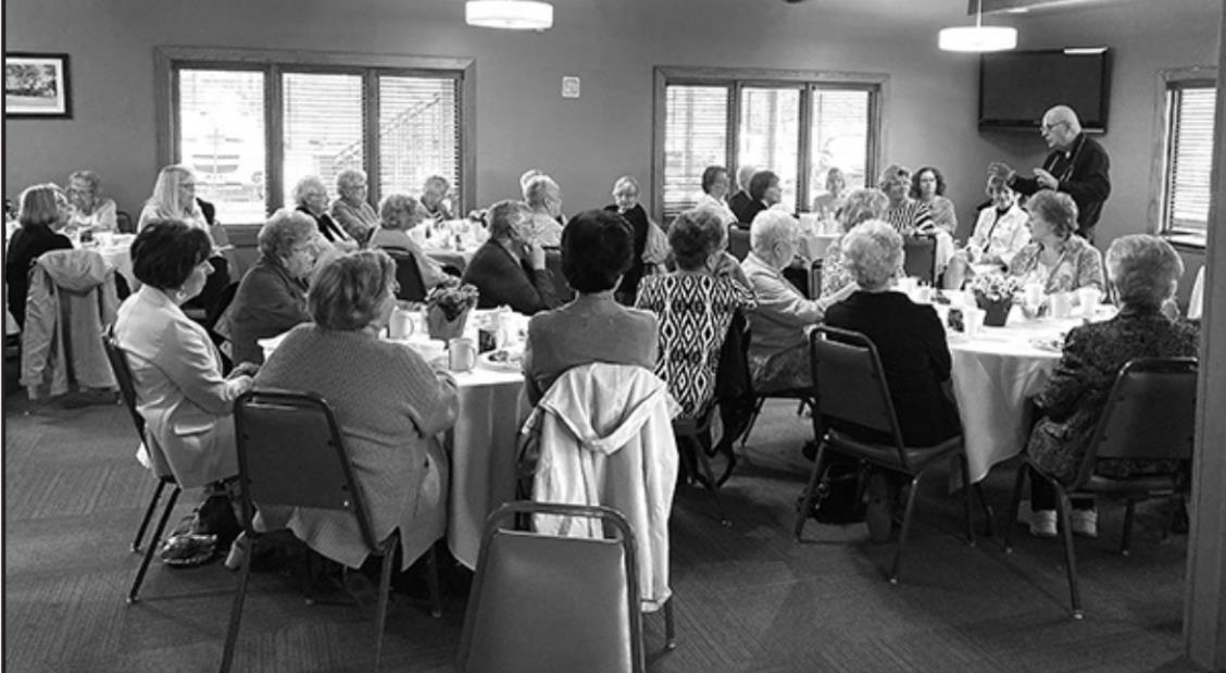 Annie Jeffrey volunteers enjoy hearing from Dr. Collins and some tasty treats.