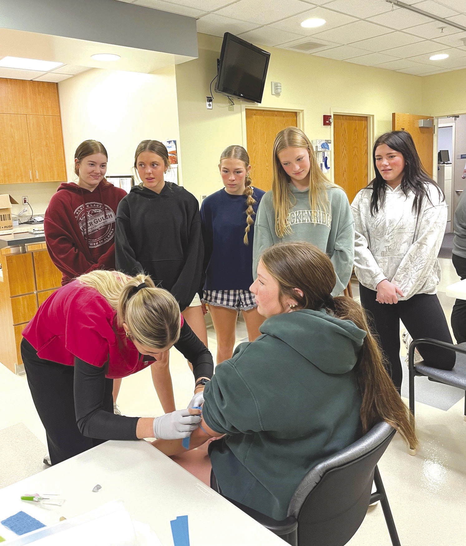 Sadie Pheak is drawing Emily Conkling as the Osceola Health Science class watches. Photo provided by AJMCHC.