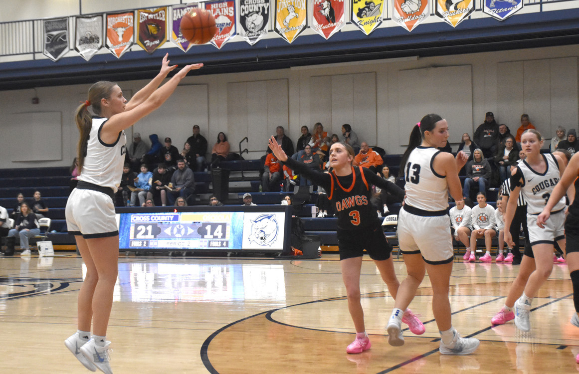 Cross County senior Edie Peterson gets a clean look at a 3-point attempt as the Osceola defense is late. Peterson scored 18 in the Cougars win on Friday. PCN photo by Beth Sparrow.