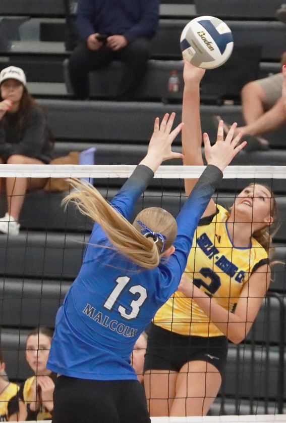 Top left- Kierslyn Cattaau hammers the attack against the Malcolm front line. Top right- Sophomore Hayden Hopwood keeps the ball in play during action against Malcolm. PCN photos by Ken Kush