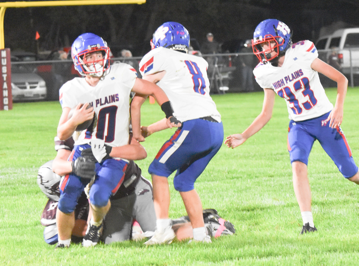 High Plains quarterback Carson Swedenburg tries to escape the grasp of the Silver lake defender in Friday night prep gridiron action. PCN photo by Beth Sparrow.