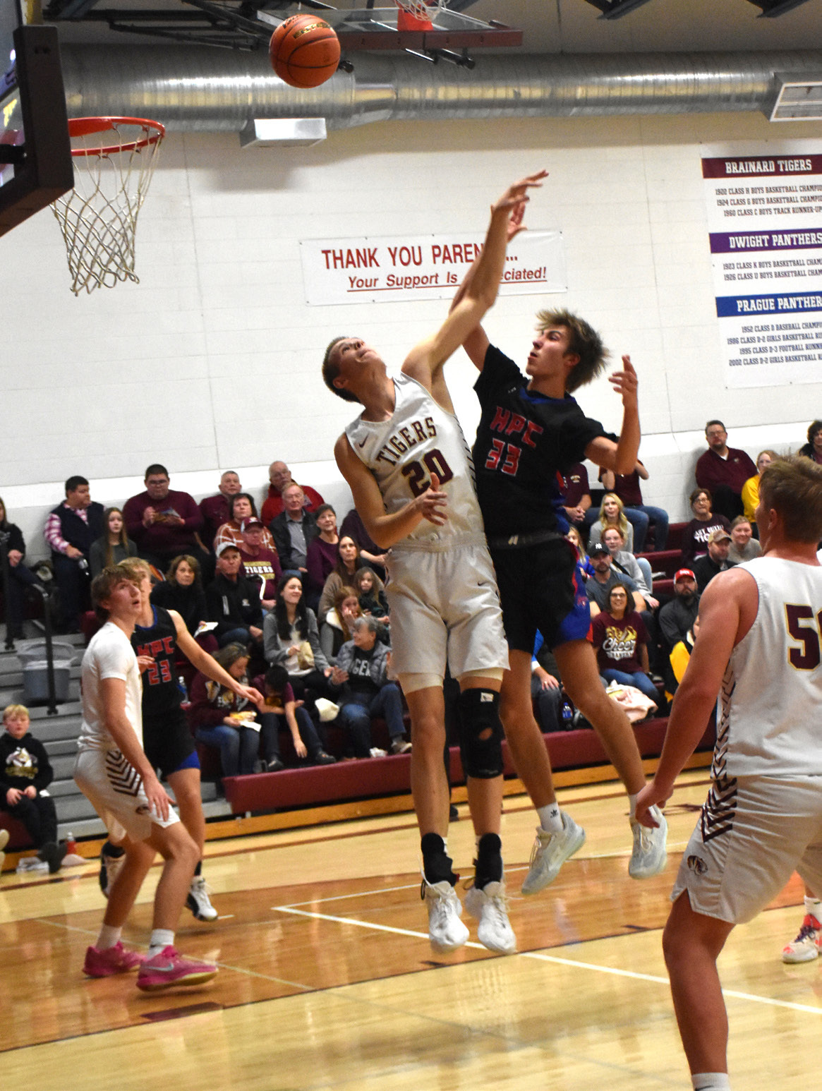 Carter Urkoski (HPC) fights Brody Johnson (EB, 6’11) for the rebound. PCN photo by Beth Sparrow.