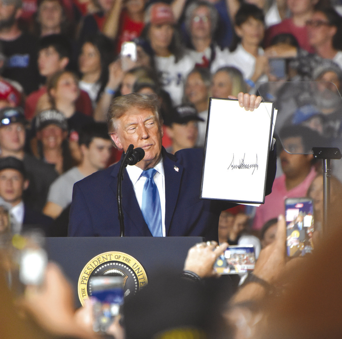 Above: President Donald Trump came to Grand Island, Nebraska to promote Republican candidates Pete Ricketts, Gov. Jim Pillen and the three Congressional representatives. Here he holds up his signed presidential order to make red diesel tax free. PCN photo by Beth Sparrow