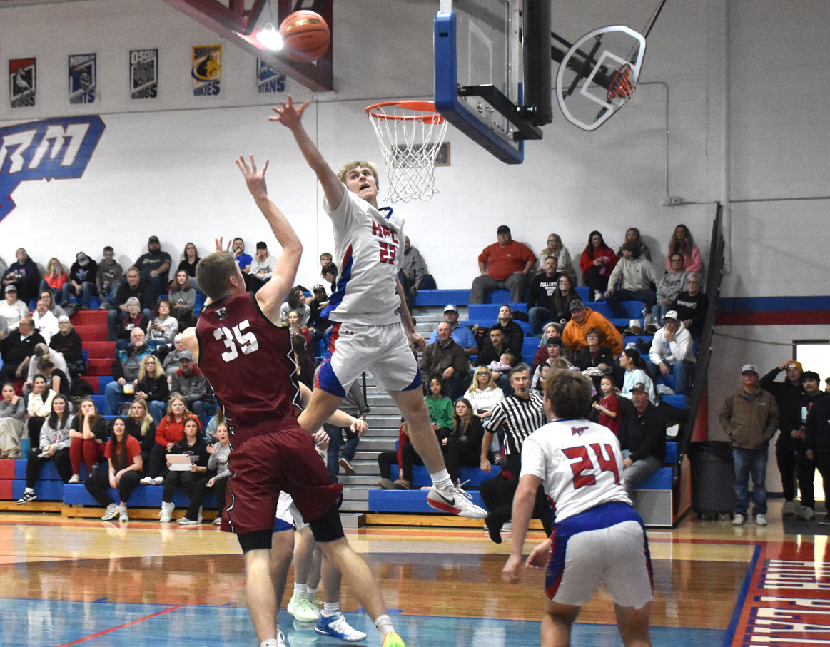 Storm senior Brodey Spurling skies as he tries to block the Fullerton Warriors shot attempt. PCN photo by Beth Sparrow.