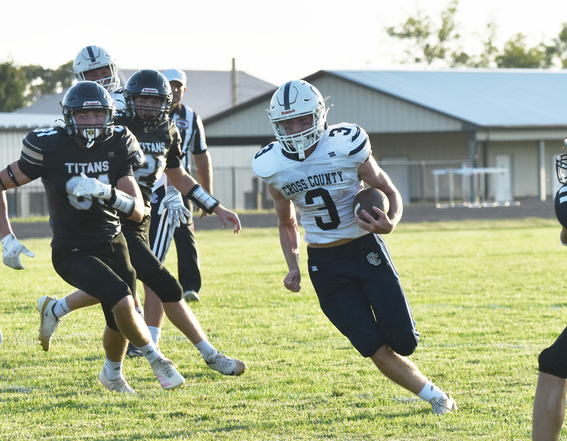 Cross County junior quarterback Eli Greenwall (3) turns the corner against the Thayer Central defense last Friday night in Hebron. Greenwall ran for three scores, returned a kickoff and finished with 156 yards on the ground. PCN photo by Beth Sparrow.