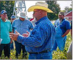 Jimmy Emmons speaks to field day attendees about adding armor to the soil with cover crop residue to reduce compaction. Photo provided.