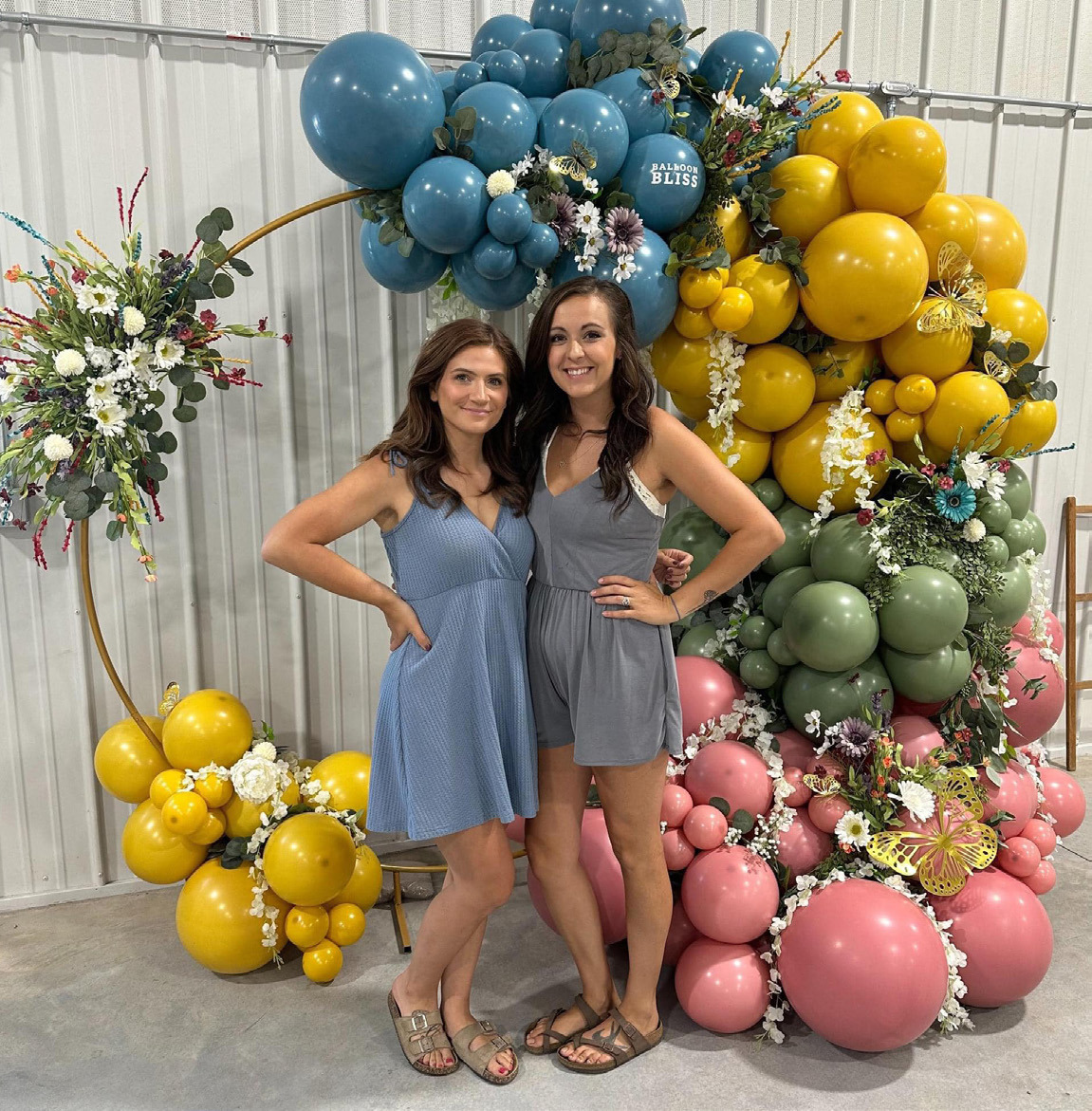Best friends Valarie Marak and Emily Carlson recently started Balloon Bliss. They are pictured here at the Osceola Garden Tour. Photo provided.