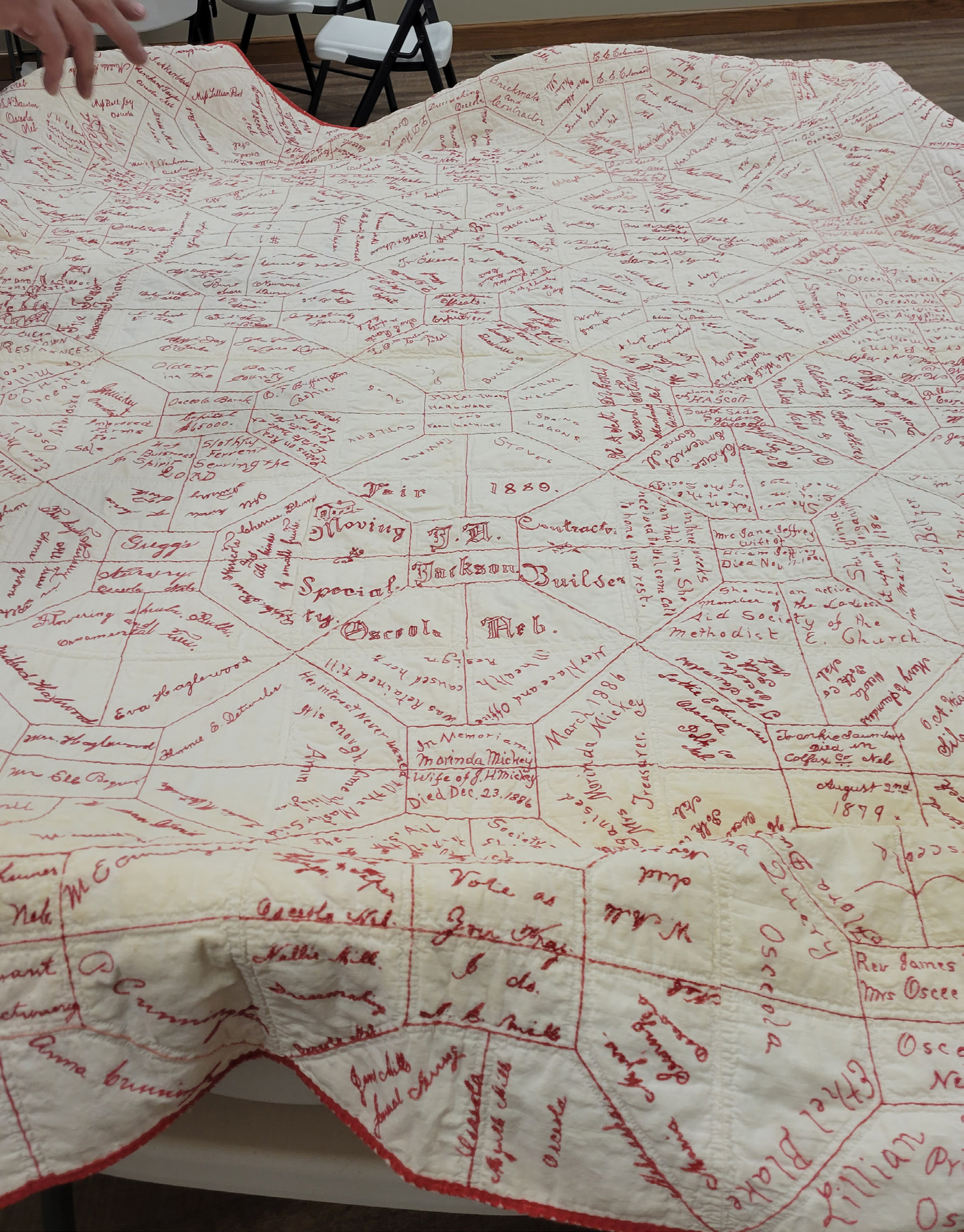 This souvenir quilt from 1889 will be on display at the church with others on September 10th at the Polk County Museum. Photo by Beth Sparrow.