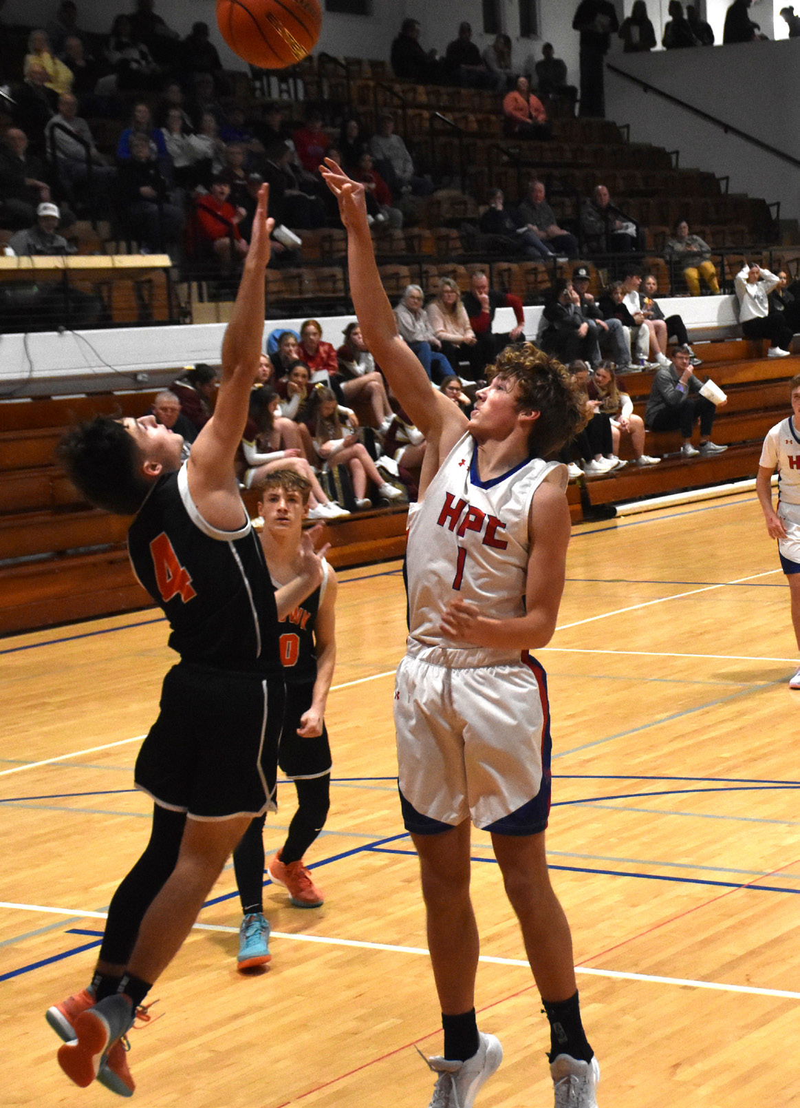 Brayden Santos (Osc) goes up against Collin Howell (HPC) for a rebound. PCN photo by Beth Sparrow.