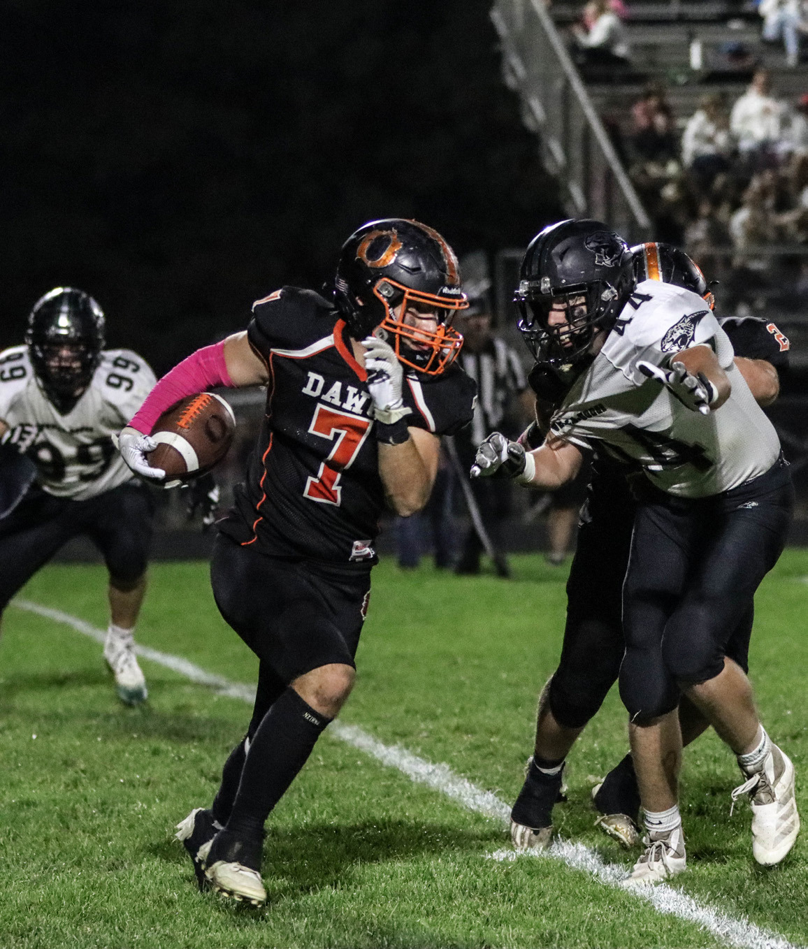 Aden Feezell runs the ball and tries to avoid the tackler. PCN photo by Blaine Winslow.