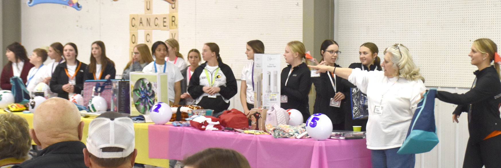 Polk County Health Department hands out door prizes with help from Osceola and Shelby-Rising City cheer teams. PCN photos by Beth Sparrow