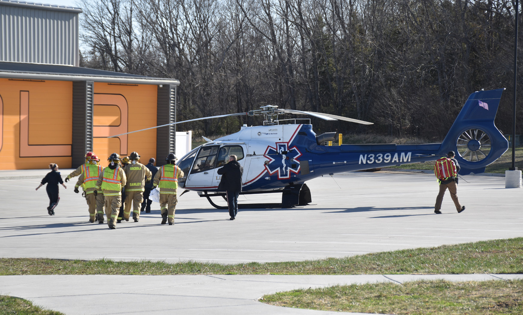 Above: Osceola rescue workers carry the Osceola student volunteer to the Life Net helicopter in Monday's docudrama. Below: Sheriff Ladwig checks Hayden Lavaley for injuries. PCN photo by Beth Sparrow.
