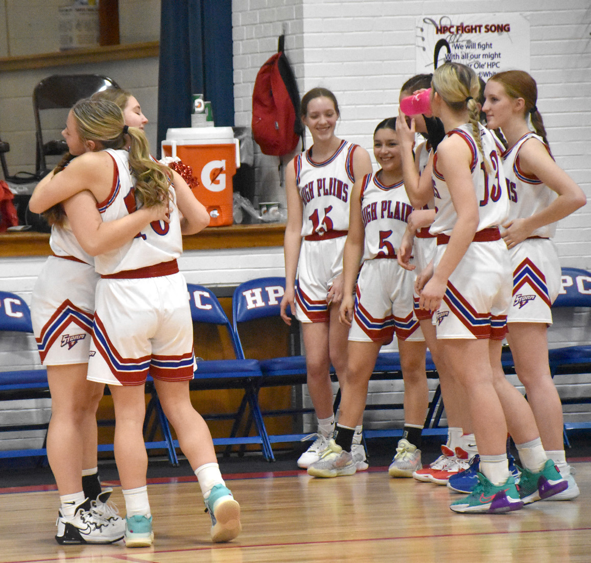 Emily Ackerson and Hailey Lindburg share a moment before High Plains home game last week. PCN photo by Beth Sparrow
